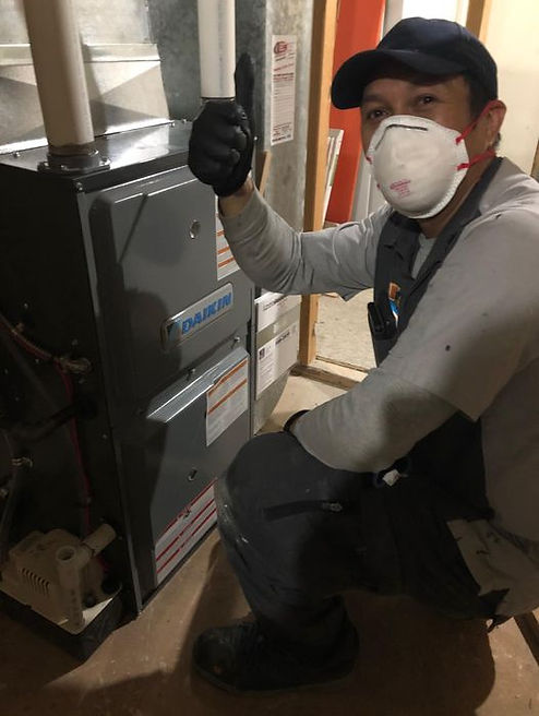 Tradesman technician servicing a furnace